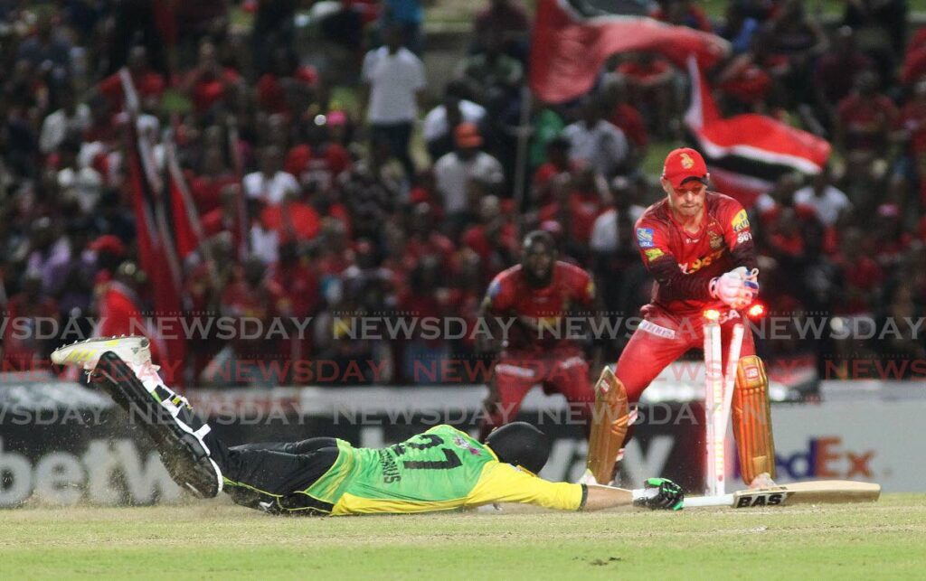 Migael Pretorious (on ground) survives a run-out attempt by Trinbago Knight Riders wicketkeeper Tim Seifert (right) during the Hero Caribbean Premier League contest between the TKR and the Jamaica Tallawahs at the Brian Lara Cricket Academy, Tarouba on Saturday. - Lincoln Holder