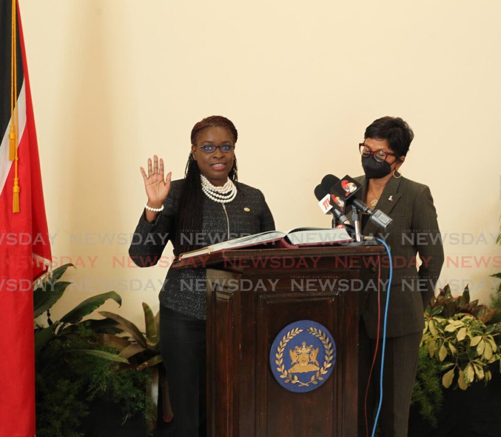New THA Deputy Chief Secretary Faith BYisrael, left, is sworn into the post by acting President Christine Kangaloo at a ceremony at President's House, St Ann's Port of  Spain, on Monday. - ROGER JACOB