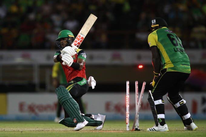 Guyana Amazon Warriors batsman Shai Hope (left) is bowled by Jamaica Tallawahs' Mohammad Nabi during the teams' Hero Caribbean Premier League match at the Providence Stadium, Guyana on Wednesday. Also in photo is Tallawahs wicketkeeper Kennar Lewis. PHOTO COURTESY CARIBBEAN PREMIER LEAGUE. - 