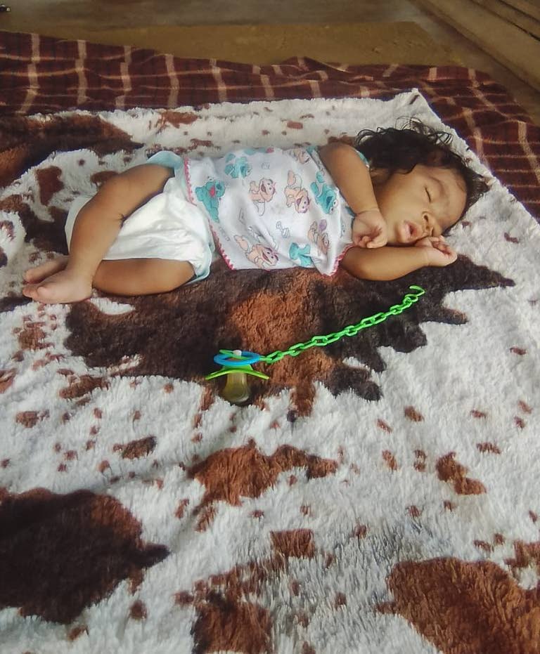 FUNERAL SET: Poisoned baby girl Selieen Ramsaroop who will be laid to rest on Thursday. The nine-month-old is seen asleep at her New Grant home in this photo provided by her relatives.  - 