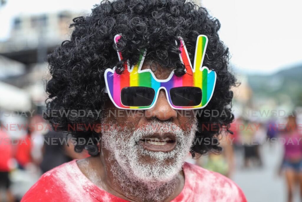 A reveller adds some rainbow funk to his mas. - JEFF K MAYERS