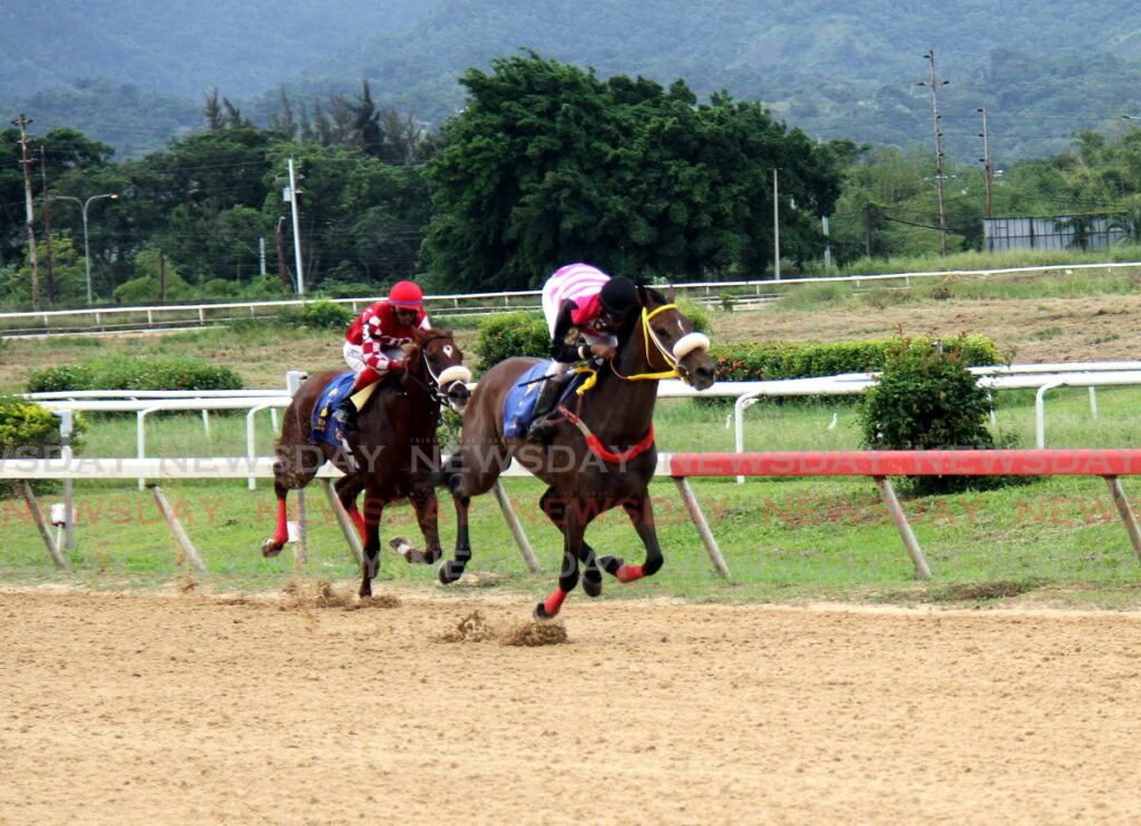 Veteran jockey Nobel Abrego, right, aboard Soca Harmony, finishes first, followed by Crown Prince, ridden by Brian Boodramsingh, in the Carib Trinidad Derby Stakes, on the Republic Day horse racing at the Santa Rosa Race Park, Arima. - AYANNA KINSALE