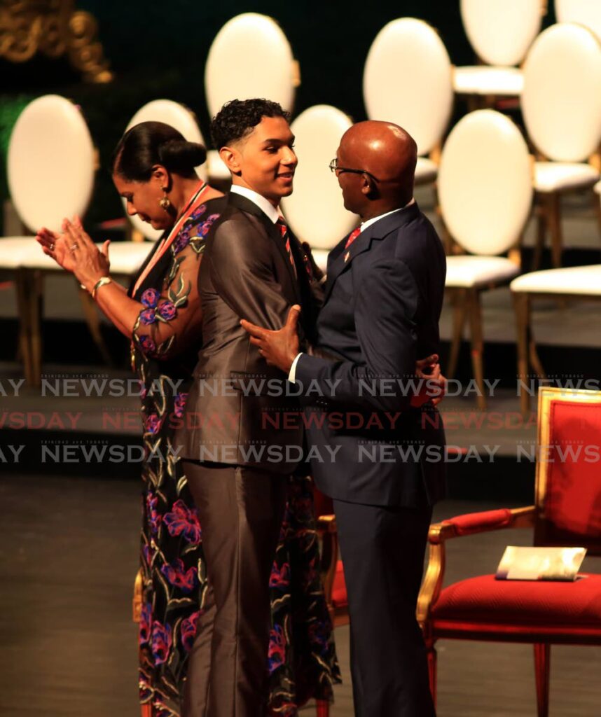 President Paula-Mae Weekes applauds as Prime Minister Dr Keith Rowley congratulates teen Gregg Mannette on his national award for gallantry at NAPA, Port of Spain on Saturday. - SUREASH CHOLAI