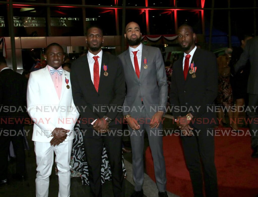 Members of the Commonwealth Games 4x400-metre relay gold medal team (left-right) Che Lara, Asa Guevara, Machel Cedenio and Jereem Richards, with their Humming Bird Medal Gold, at the National Academy for the Performing Arts (NAPA), Port of Spain on Saturday. - SUREASH CHOLAI