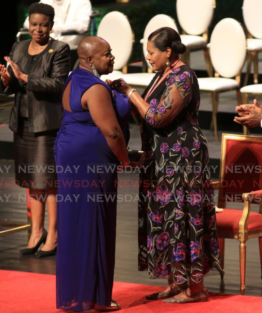 Tobagonian Charmaine Archer receives the Hummingbird silver from President Paula-Mae Weekes.  - SUREASH CHOLAI