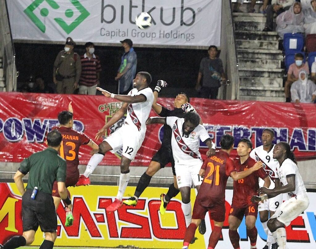 Trinidad and Toabago's Kareem Moses (12) goes airborne for a header against Thailand, on Sunday, during the King's Cup third playoff match, at the Chiang Mai Stadium, Thailand. - TTFA Media