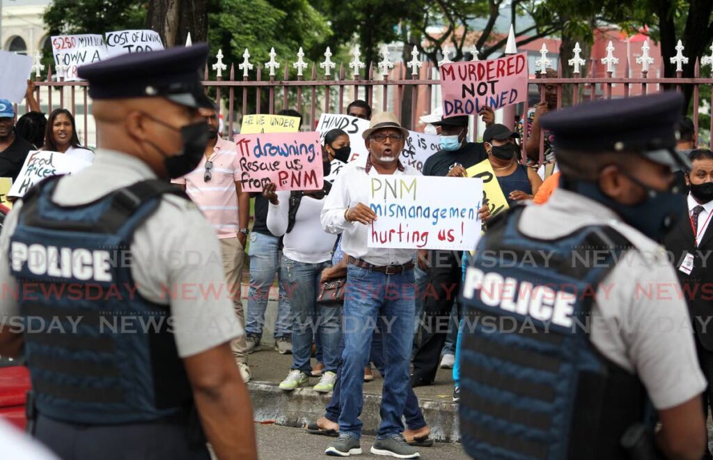 The police maintained law and order as protesters gathered outside Parliament on Monday ahead of the budget reading by Finance Minister Colm Imbert. Photo by Roger Jacob