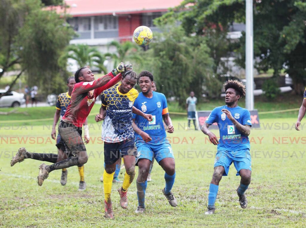 Speyside High goalkeeper Andre Fraser punches the ball away from goal during the Secondary Schools Footbal League game at Lewis Street, San Fernando, on Monday. - Lincoln Holder