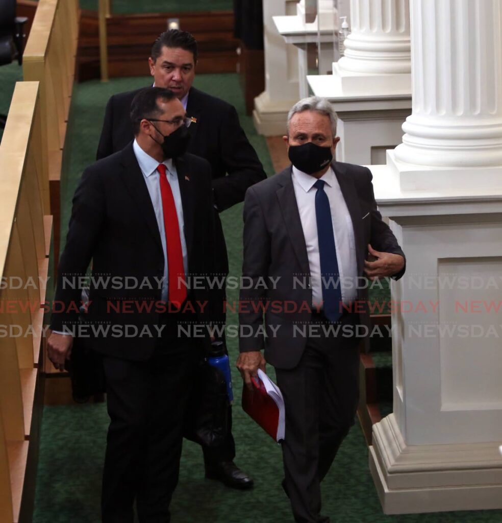 Finance Minister Colm Imbert with Energy Minister Stuart Young   and Communications Minister Symon de Nobriga leave parliament after the budget reading on Monday. Photo by Sureash Cholai