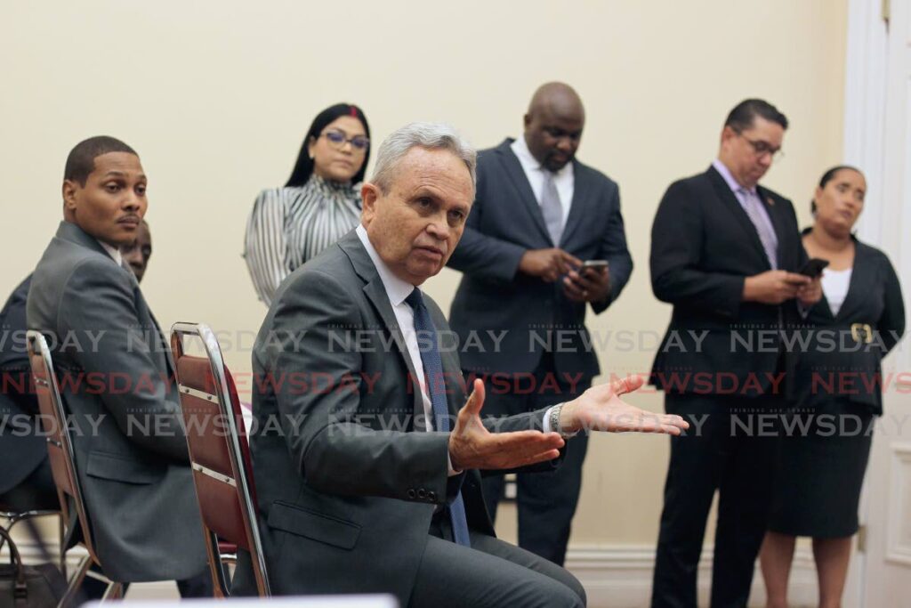 Finance Minister Colm Imbert responds to reporters during a post-budget media conference at Parliament on Monday. From left are Nigel De Freitas, Renuka Sagramsingh-Sooklal, Brian Manning, Symon De Nobriega and Lisa Morris-Julian. - PHOTO BY ROGER JACOB