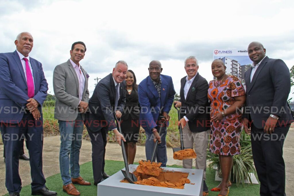 Prime Minister Dr Keith Rowley (centre), CEO of the Furness Trinidad Group of Companies, William Ferreira (left of PM) and CEO at Home Solutions Luis Dini (right of PM), joined by other government officials, turn the sod for City Heights housing development at the San Fernando by-pass and Naparima Mayaro Road on Tuesday morning. Photo by Marvin Hamilton