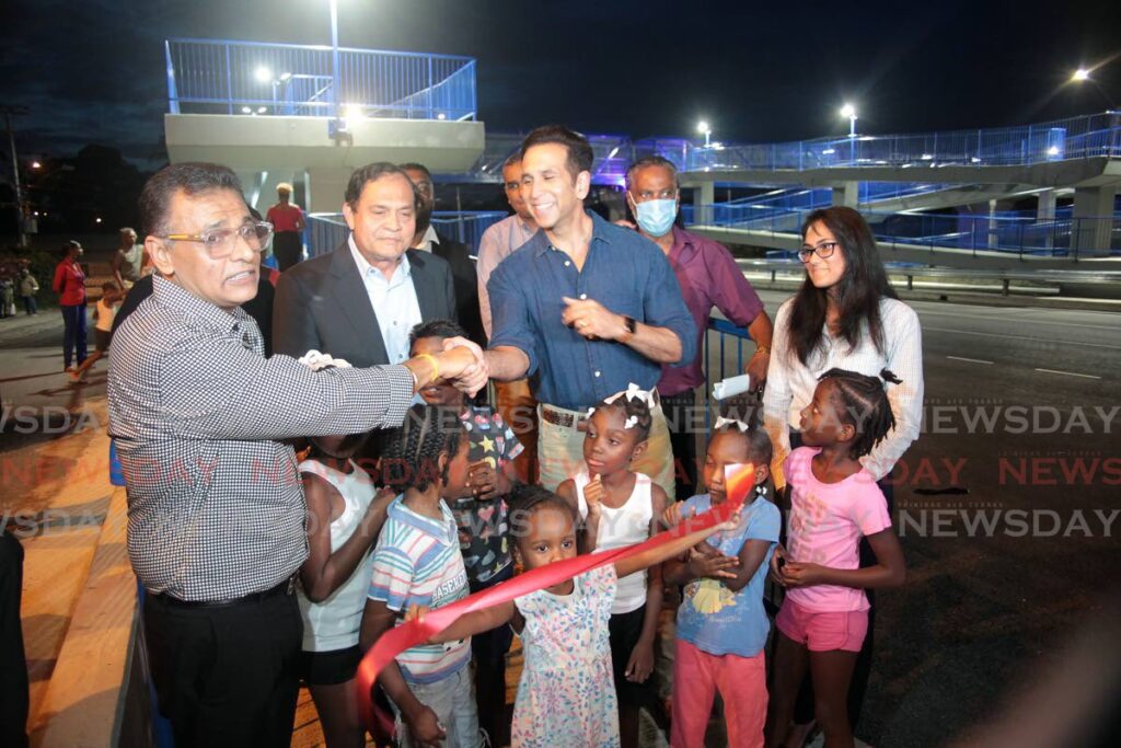 Minister of Works and Transport Rohan Sinanan, Chairman of the Coosal group of companies Sieunarine  Persad Coosal, San Fernando West MP Faris Al Rawi and children of the Embaccadre use the  the Rienzi Kirton Highway Overpass.  Photo by Lincoln Holder