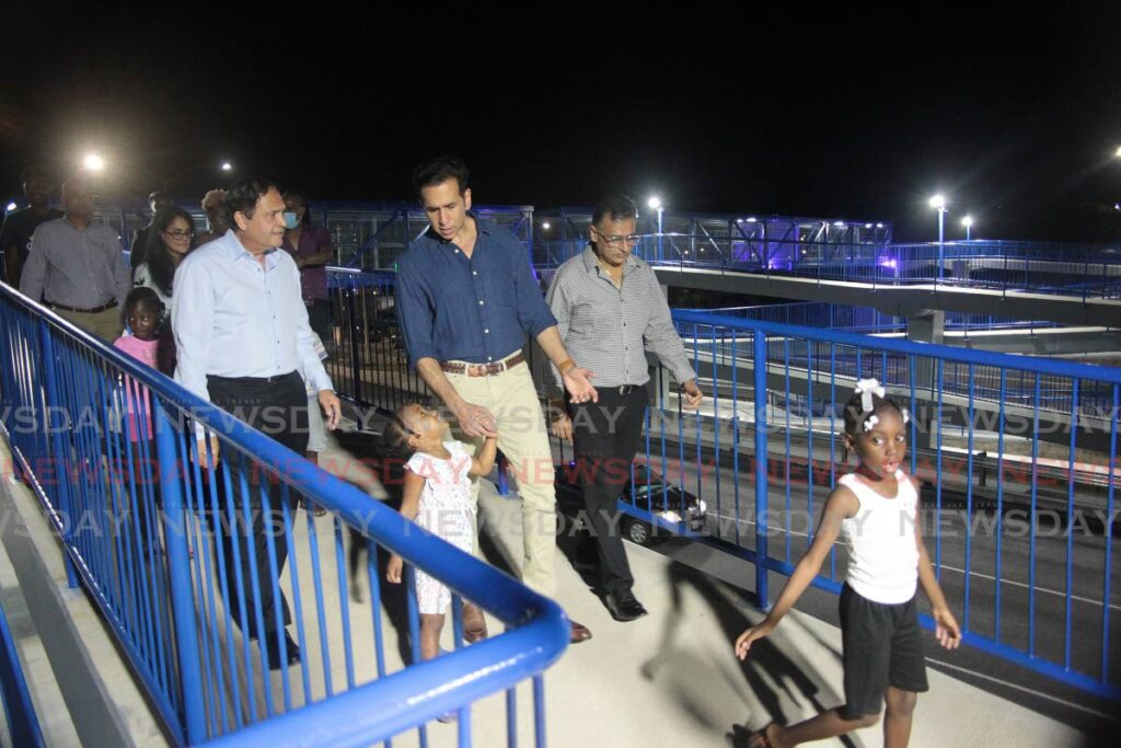 Minister of Works and Transport Rohan Sinanan, Chairman of the Coosal group of companies Sieunarine  Persad Coosal, San Fernando West MP Faris Al Rawi and children of the Embaccadre use the  the Rienzi Kirton Highway Overpass.  Photo by Lincoln Holder