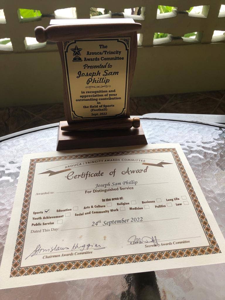 A plaque and a certificate which were presented to Joseph Sam Phillip by the Arouca/Trinity awards committee on Saturday. - 