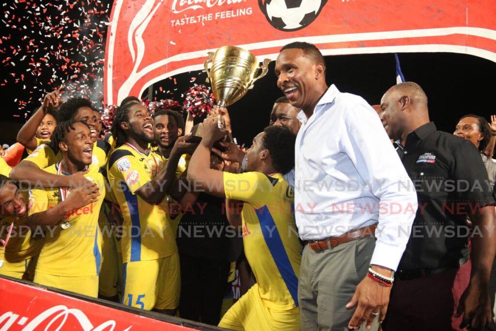 In this December 4, 2019 file photo, former TT footballer Shaka Hislop (second from right) presents members of Presentation College San Fernando with the Coca-Cola Intercol trophy, after they defeated San Juan North Secondary in the final, at the Ato Boldon Stadium, Couva. Photo by Marvin Hamilton