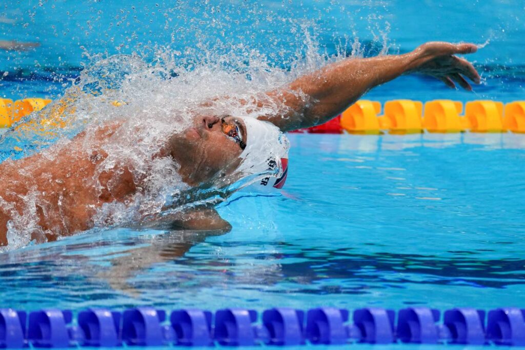 In this July 25, 2021 file photo, Dylan Carter, of Trinidad And Tobago, swims in a heat during the men's 100m backstroke at the 2020 Summer Olympics, in Tokyo, Japan. (AP Photo) - 