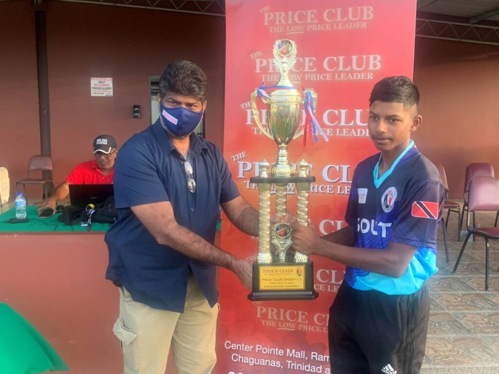 Captain of the South Under-15 cricket team Brendan Boodoo collects The Price Club Supermarket Trophy from Mr Shamshad Ali after South defeated South in the first North South Classic on April 17, at the National Cricket Centre in Balmain, Couva. Photo courtesy TT Cricket Board 