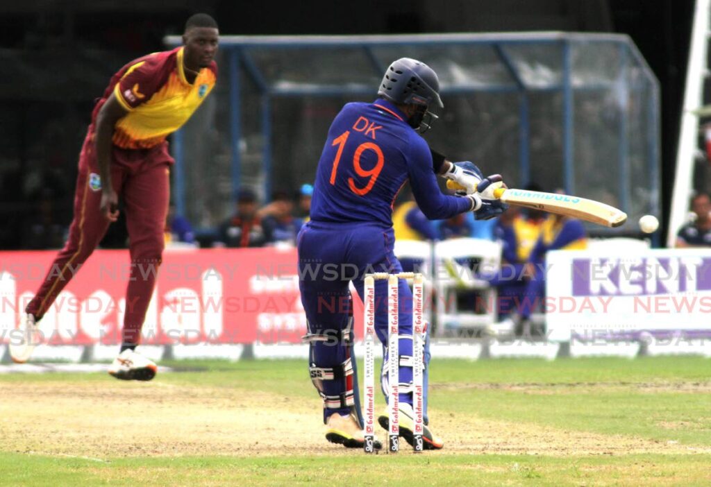 Jason Holder sends down a fiery delivery to India batsman Dinesh Karthik. Photo by Ayanna Kinsale