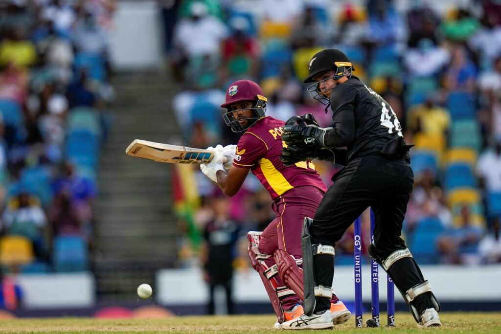 West Indies' captain Nicholas Pooran plays a shot under the watch of New Zealand's captain Tom Latham during the third ODI at Kensington Oval in Bridgetown, Barbados, on August 21. (AP PHOTO) - 