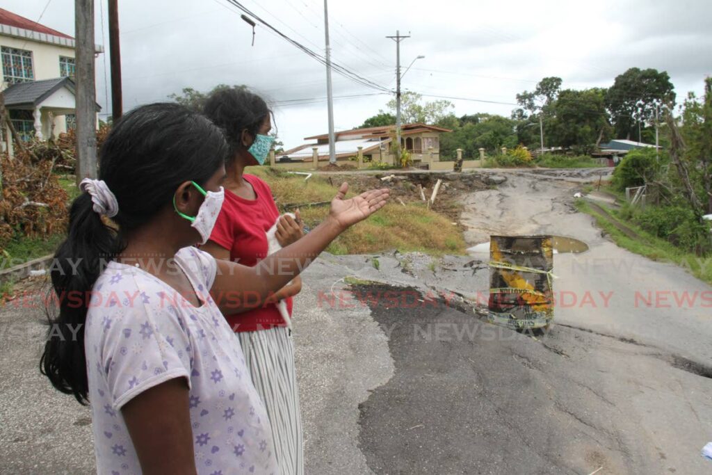 Marlene and Nareefa Shadick raise concerns about damage to Pluck Road, San Francique where the Ministry of Works and Transport planned to be begin stablisation works in September. - MARVIN HAMILTON