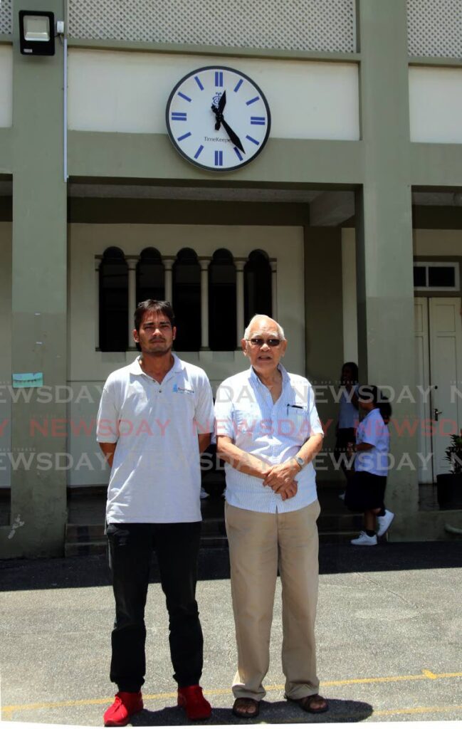 In this file photo, timekeepers Zack Pantin, left, and Michael J Williams in front of the clock they repaired at St Joseph Convent , on Abercromby Street in Port of Spain. - Sureash Cholai
