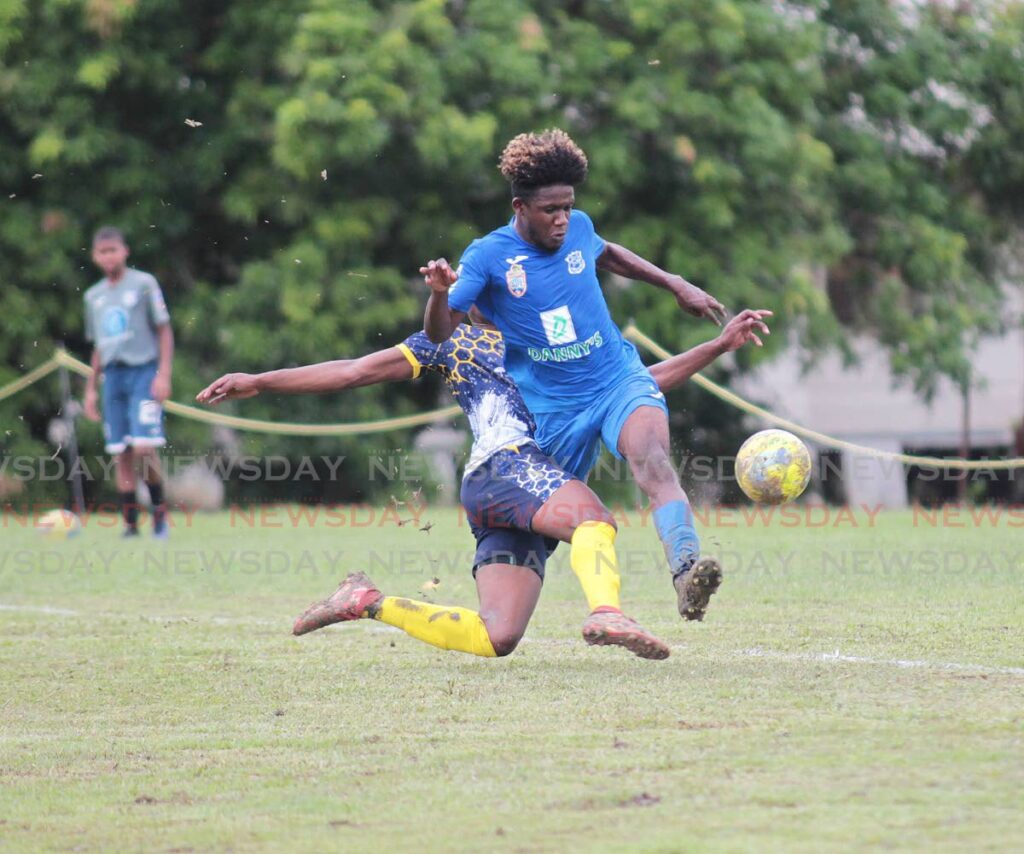 In this Sep 26 photo, Naparima College's Nathaniel O'Garro skips over a challenge from a Speyside High School player at the Secondary Schools Football league match at Lewis Street, San Fernando. - Lincoln Holder