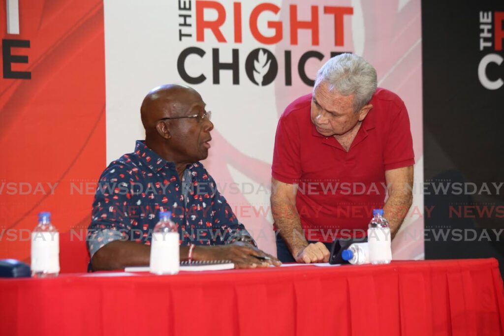 YOU TALK AFTER ME: Finance Minister Colm Imbert speaks with Prime Minister Dr Keith Rowley, shortly after the latter arrived at the PNM's post budget forum in Mt Hope on Friday night. PHOTO BY SUREASH CHOLAI - 