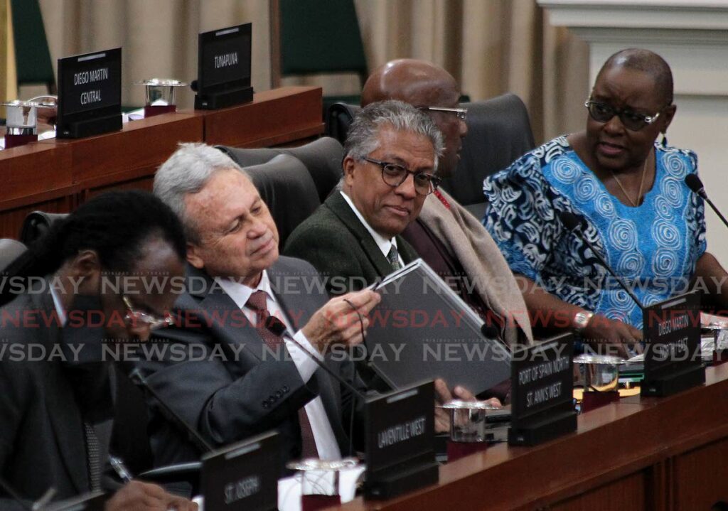 at left, Mr. Colm Imbert, Minister of Finance, connect the pluggin charge to his laptop, while Mr. Reginald Armour SC, Attorney General looks on,
alongside Fitzgerald Hinds National Security, PM Dr. Keith Rowley and Mrs. Camille Robinson-Regis Planning and Development Minister,
The debate of the Budget 2023 presentation by Membes of Parliament, House of Representatives,

Parliament Chamber, Red House.
Saturday, October 2022. - ROGER JACOB