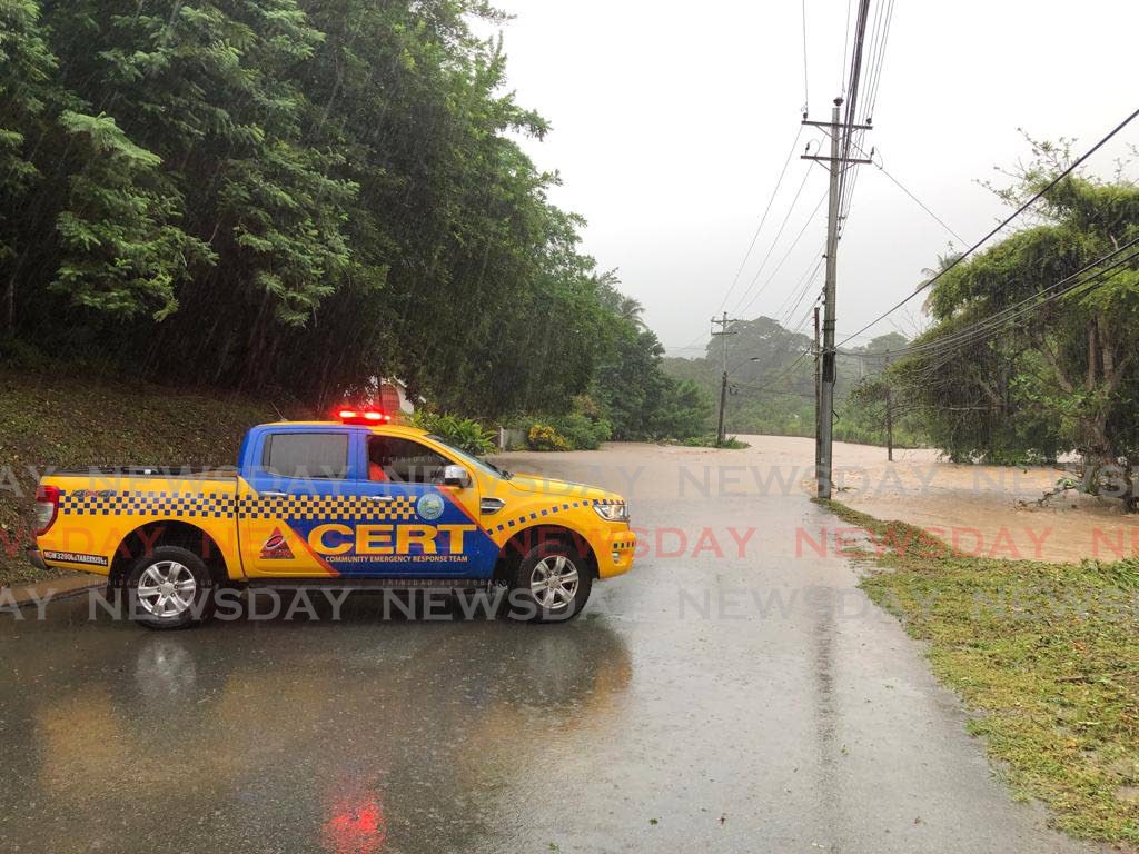 A Community Emergency Response Team (CERT) vehicle parked to block vehicles from attempting to drive through a flooded part of the road to Turtle Beach on Wednesday.  - David Reid
