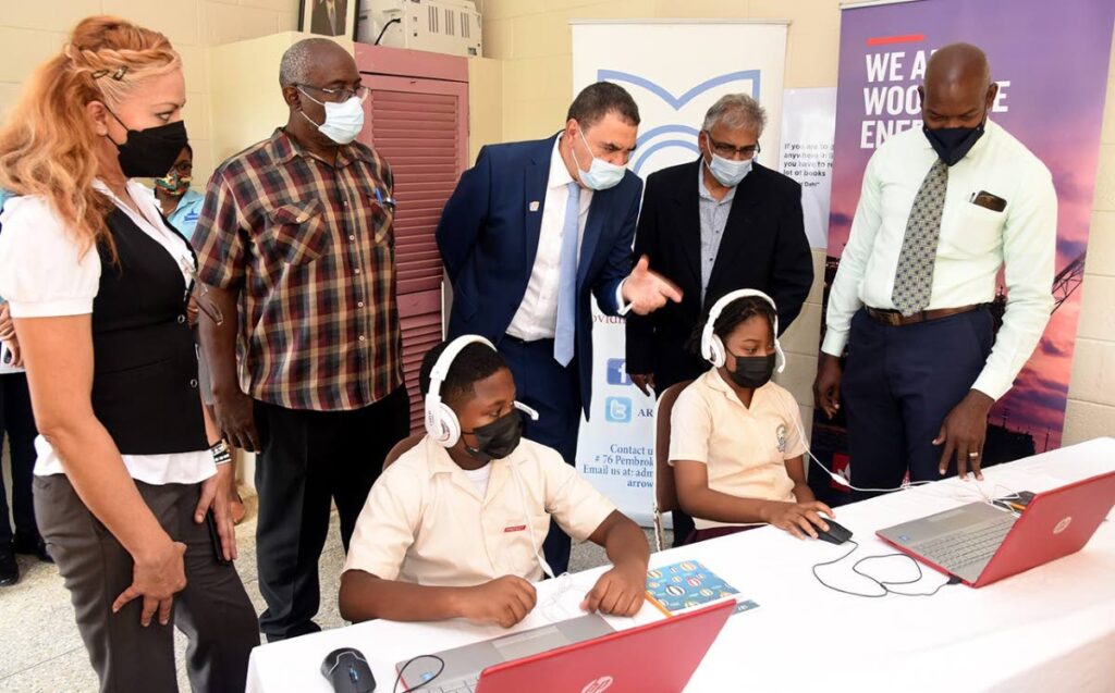 Christopher Bonterre, centre, of the Arrow Foundation, guides a student demonstration of the Arrow training software. Looking on are from left: Sarah McKenzie, principal, Toco RC Primary School; Julien Louis, senior teacher, Toco Anglican Primary School; Sheldon Narine, corporate adviser, Woodside Energy; and Darrin Parkes, standard five teacher at Matura Government Primary School. - 