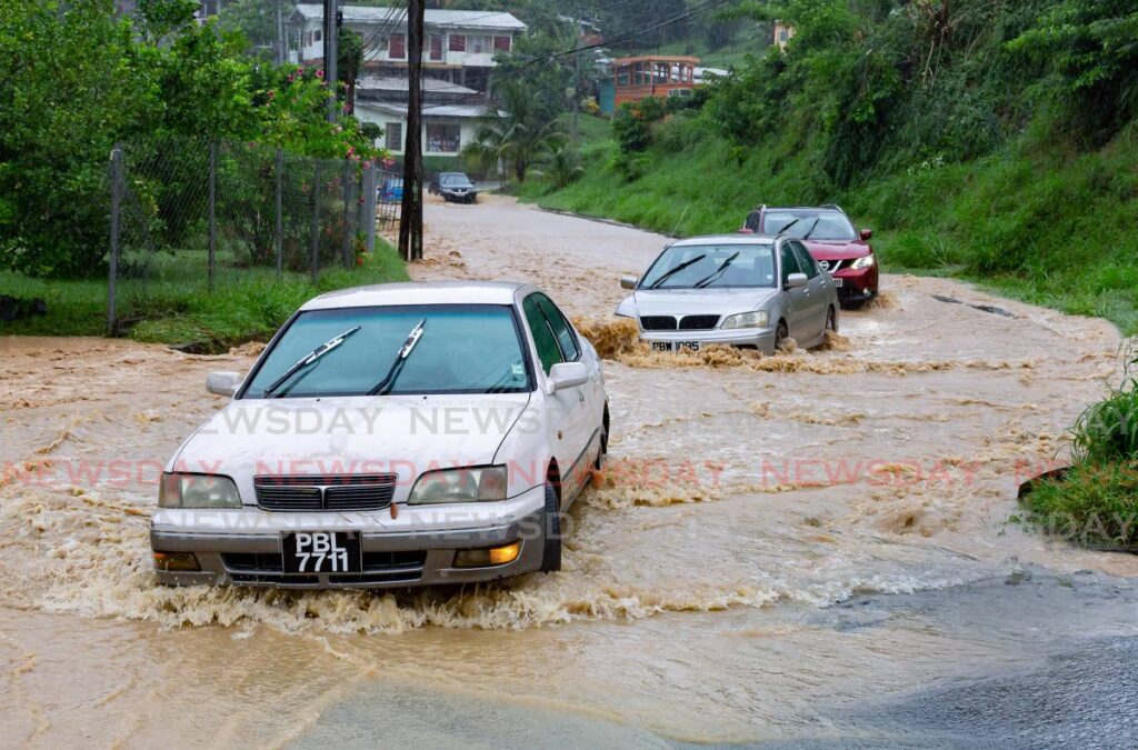 Drivers take a chance through the flood at Whim Village, Tobago.  File photo/David Reid