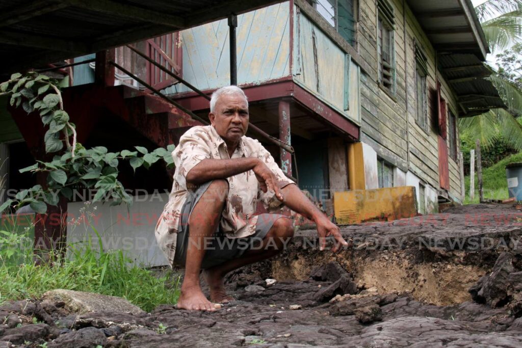Ramdeo Ramoutar points to the seperation in his yard caused by land movement at Skinner Trace, Quarry Village, Siparia. - Photo by Ayanna Kinsale
