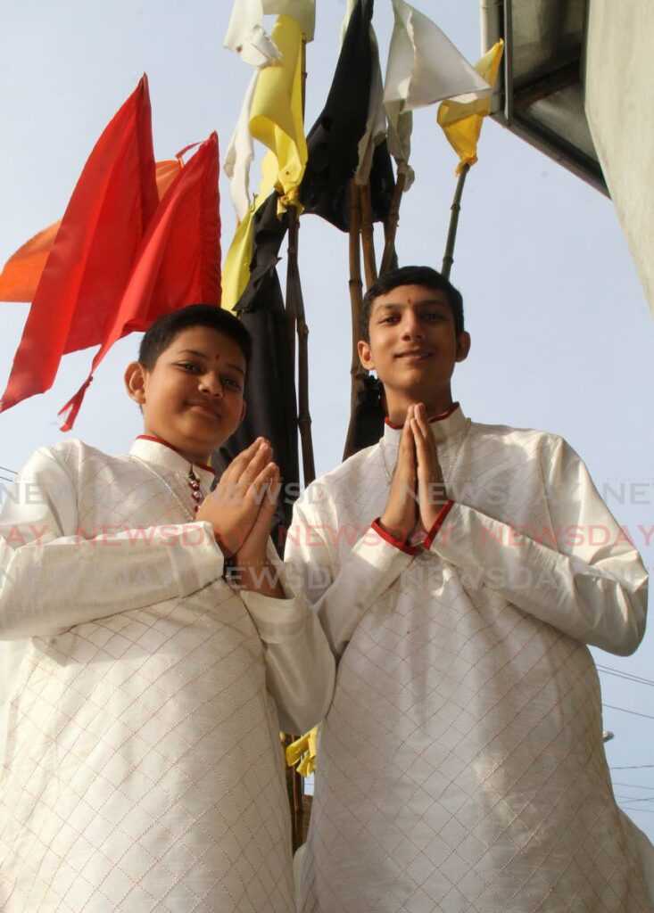 Brothers Arvind, left, and Aditya Maharaj at the Milton Shiva Mandir, Milton Road, Couva. - Photo by Ayanna Kinsale