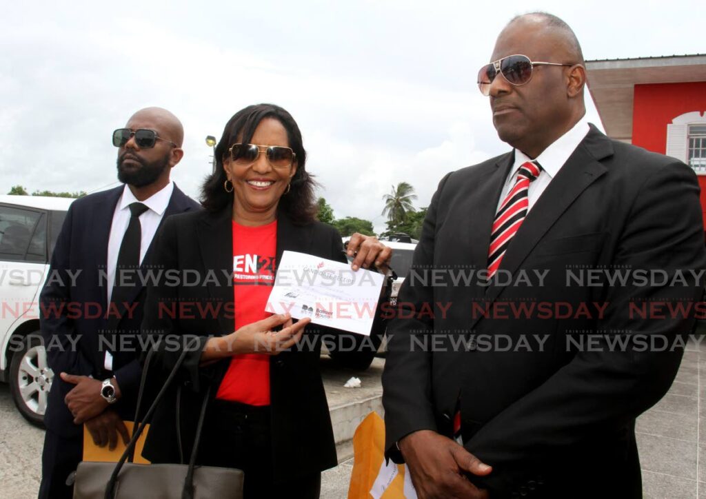 In this file photo, attorney Karen Nunez-Tesheira, centre, shows off her receipt after filing her nomination on October 10 to contest the post of PNM political leader.  Also in photo are Don Millington, left, and attorney Peter Taylor.  - AYANNA KINSALE
