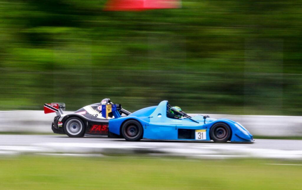 Barbados's Zane Maloney (left) and TT's Kristian Boodosingh compete in a Radical SR3 race at the Wallerfield Raceway on Sunday. PHOTO COURTESY NICHOLAS BHAJAN. - 