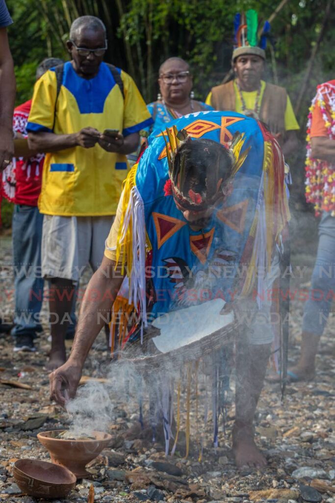 Santa Rosa First Peoples chief Ricardo Bharath Hernandez performs a ritual during the first peoples water ceremony at the Arima River, Blanchisseuse Road, Arima on October 11, 2022. - JEFF K MAYERS