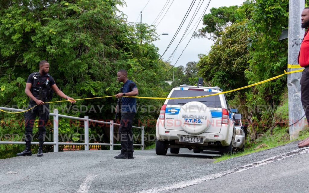 Police officers cordon off an area in Whim, Tobago where a shooting occured, on Wednesday. Photo by David Reid