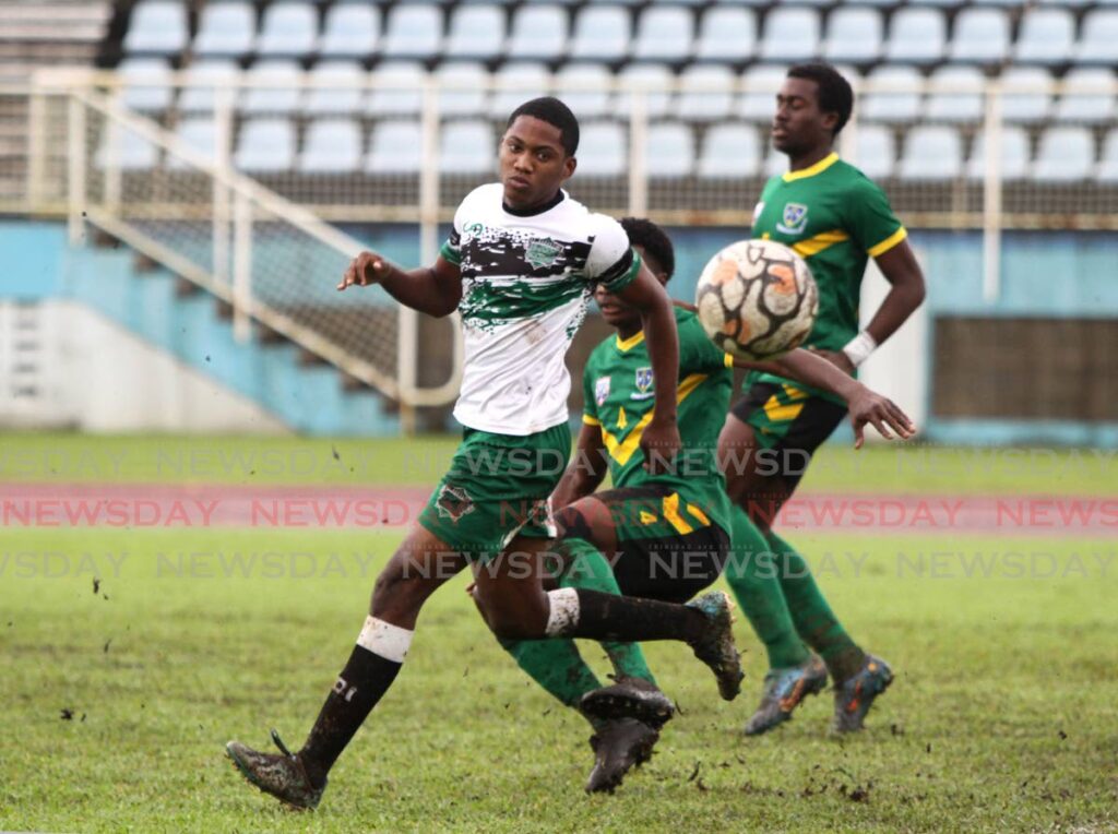 Keanu Morean (centre) of St Benedict's and St Augustine's Jeremiah Cooper (left) go after the ball during their teams' Secondary Schools Football League (SSFL) Premier Division match at the Ato Boldon Stadium, Couva on Wednesday. - AYANNA KINSALE