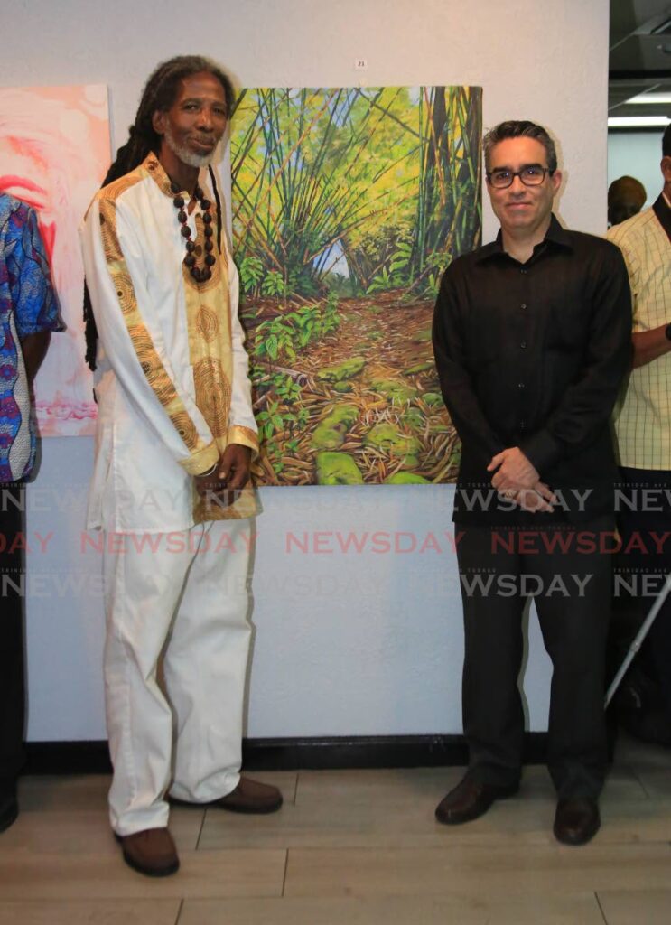 Artist Nurukhi Ato Osei and Venezuelan ambassador Alvaro Enrique Sánchez Cordero stands in front of Osei g at a function at the Venezuelan Embassy on Victoria Avenue in Port of Spain to commemorate Venezuela indigenous people resistance on Thursday evening. - Photo by Sureash Cholai
