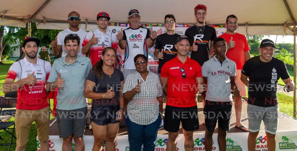 Two members of each cycling team during the opening of the Tobago International Cycling Classic at the Cyclists' Village, Johnson Apartments, Store Bay, Tobago on October 13, 2022. - David Reid