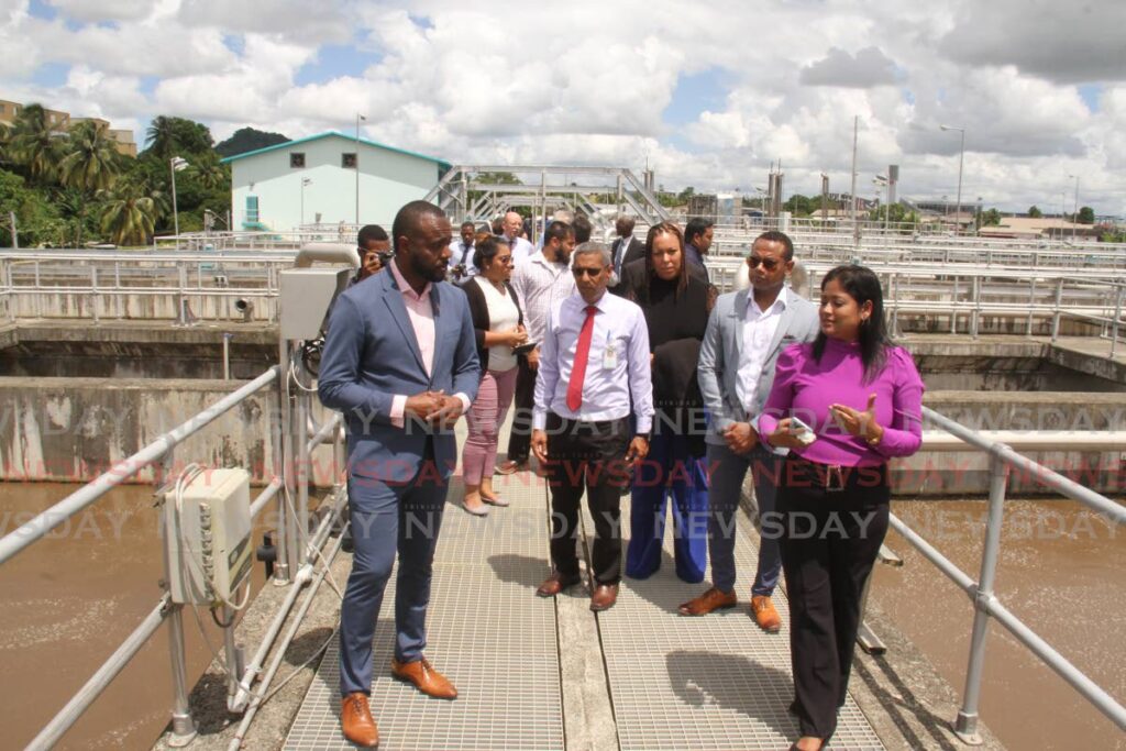 Public Utilities Minister Marvin Gonzales, left, with WASA acting project manager Indrani Ramdhanie, right, and officials during the tour of the San Fernando Wastewater Treatment Plant on Friday. - Photo by Marvin Hamilton