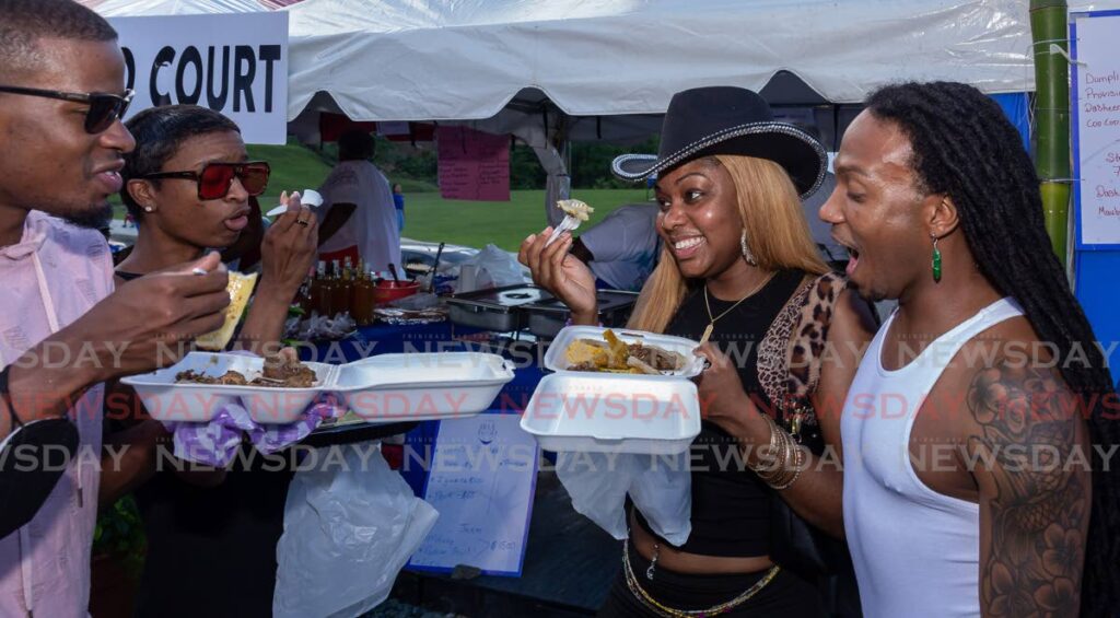 A group of friends from Atlanta, USA enjoy local meals at Blue Food Festival, Bloody Bay, Sunday. - Photo by David Reid