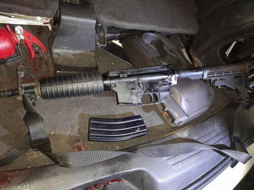 An AR 15 assault rifle and magazine found and seized by police at Beetham Gardens on Monday morning.
 Photo courtesy TTPS 