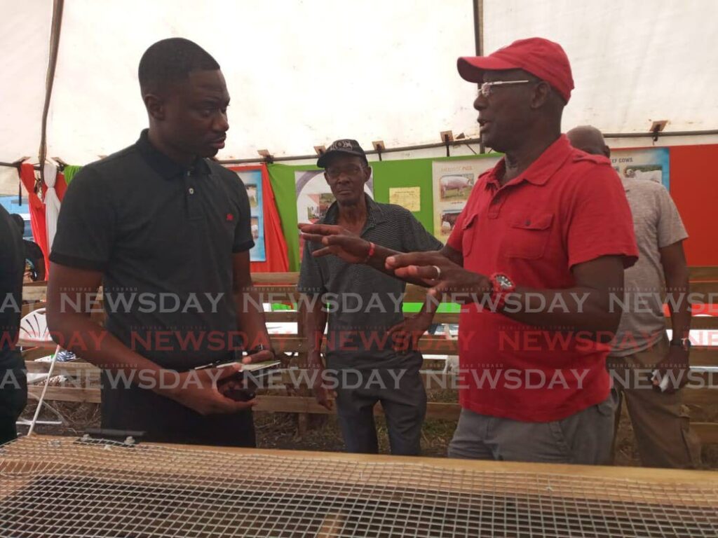 Prime Minister Dr Keith Rowley, right, chats with Chief Secretary Farley Augustine at World Food Day celebrations, Parade Grounds, Bacolet, Wednesday.  Photo by Corey Connelly