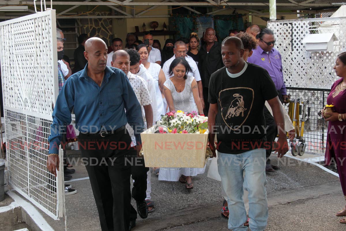 Friends and relative carry the body of  former Newsday chief photographer Rattan Jadoo following his funeral at Dow Village California