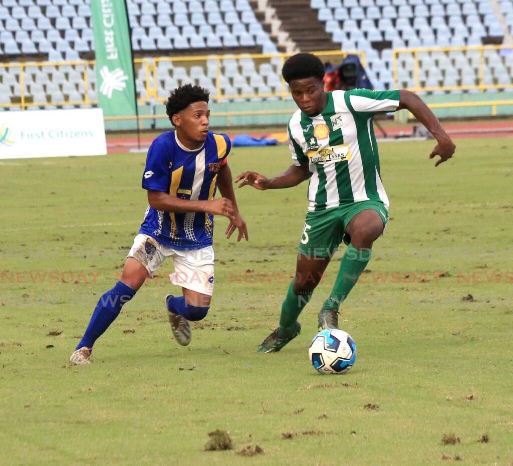 San Juan North Secondary’s Kent Guy (R) dribbles the ball away from Fatima College’s Christian Bailey, during the SSFL Premeirship division semi-final, on Saturday, at the Hasely Crawford Stadium, Port of Spain. - SUREASH CHOLAI