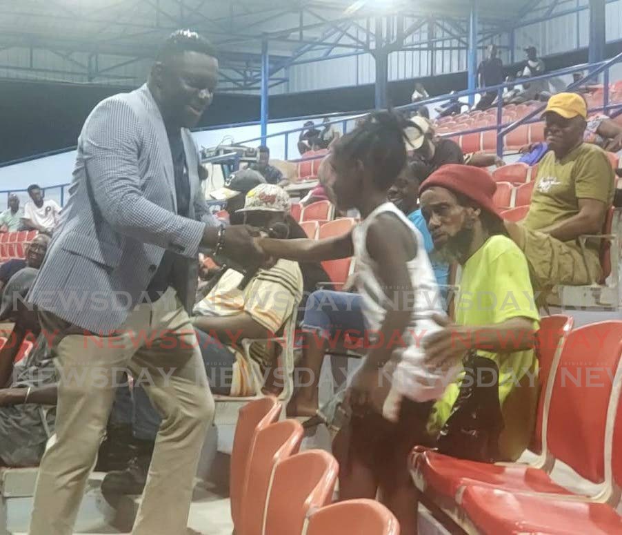 PDP leader Watson Duke meets a young supporter at the Cyd Gray Complex, Roxborough, Tuesday night.  - Photo by Elizabeth Gonzales