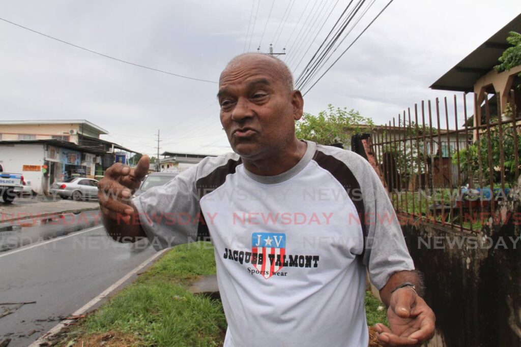 Trevor Toorie, 65, of Palo Seco vented his frustration to Newsday as the community protested on Wednesday morning by chopping down trees. - Photo by Marvin Hamilton
