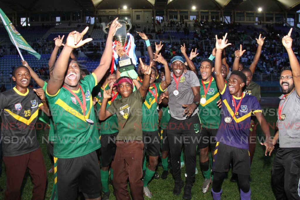 St Benedict’s College footballers celebrate with their medals and trophy, after winning the Secondary Schools Football 
League Premiership final against Fatima College at the Ato Boldon Stadium, Couva on Wednesday. 
St Benedict’s prevailed 3-1.  Photo by Marvin Hamilton