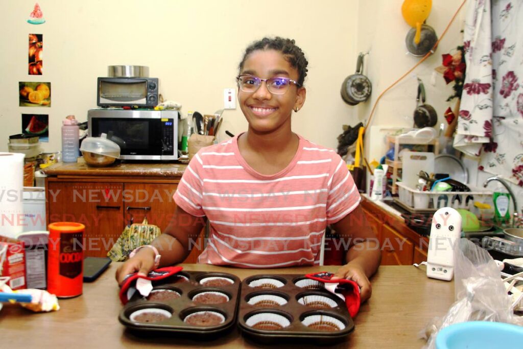 Gabrielle Temal, 11, a standard five pupil of Holy Saviour Anglican Primary, who has found joy in baking chocolate cakes at her Chaguanas home.  - ROGER JACOB